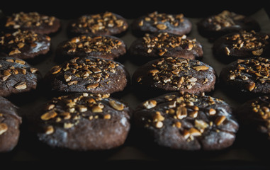 Cookies with nuts on baked on the baking sheet. Cookies close-up cooked in a bakery of a...