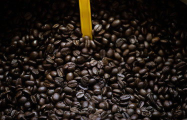Black pickled olives are photographed on the counter in front of the market. Close up.