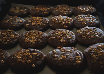 Cookies with nuts on baked on the baking sheet. Cookies close-up cooked in a bakery of a...