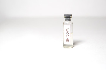 A medical bottle labeled VACCINE. Ampoule on a white background, isolate, space for text