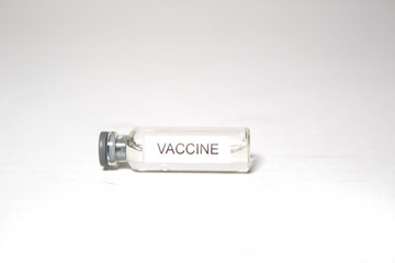 A medical bottle labeled VACCINE. Ampoule on a white background, isolate, space for text