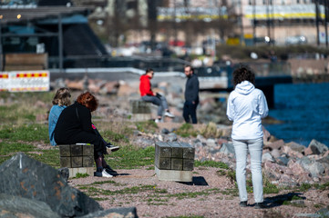 People enjoying sunny day outdoors during coronavirus lockdown in Helsinki.