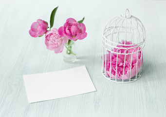 Small bird cage with peony flower bouquet, invitation card template with text space, Modern scandy style interior.