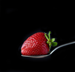 fresh ripe strawberry on black background