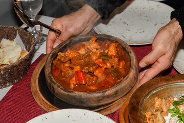 Home cooked lamb and beef or pork stew, served in a traditional restaurant, in wooden bowl