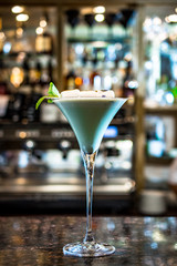 White cocktail with burned marshmallows in a bar
