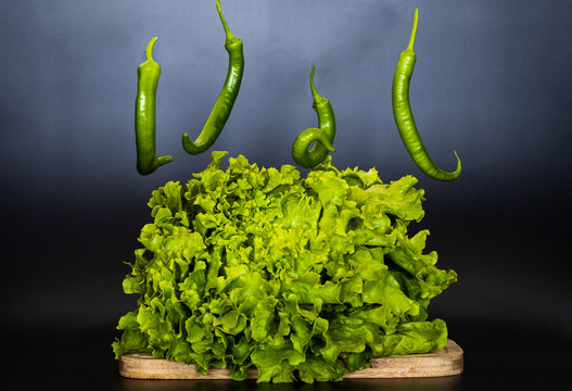 falling peppers and kail on the cutting board, food concept, fresh vegetables