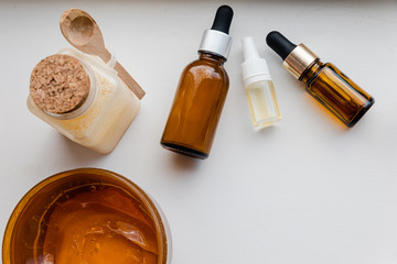 Beauty care products flat lay on scratched white background