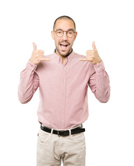 Fototapeta premium Amazed young man making a gesture of calling with the hand