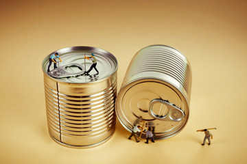 Group of workers opening a tin can with crowbar