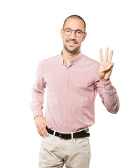 Young man making a number three gesture