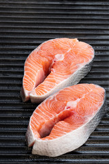Fresh salmon steak on black grill. Ready for cooking