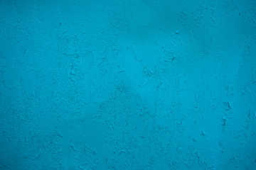Turquoise background of old-age paint. Abstraction. Blue board with cracks from paint. Old wall background.