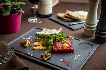Fresh beef meat tartar with green leaves
