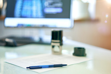 desktop in the office with documents and a seal