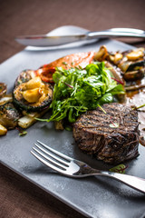 Grilled beef meat with grilled vegetables, gravy
