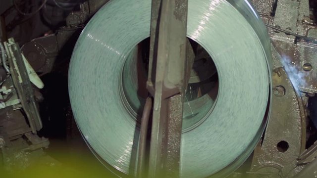 Roll of metal sheets on industrial machine. Automation of work.