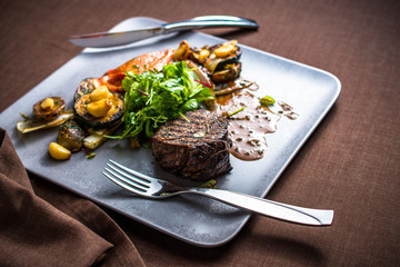 Grilled beef meat with grilled vegetables, gravy