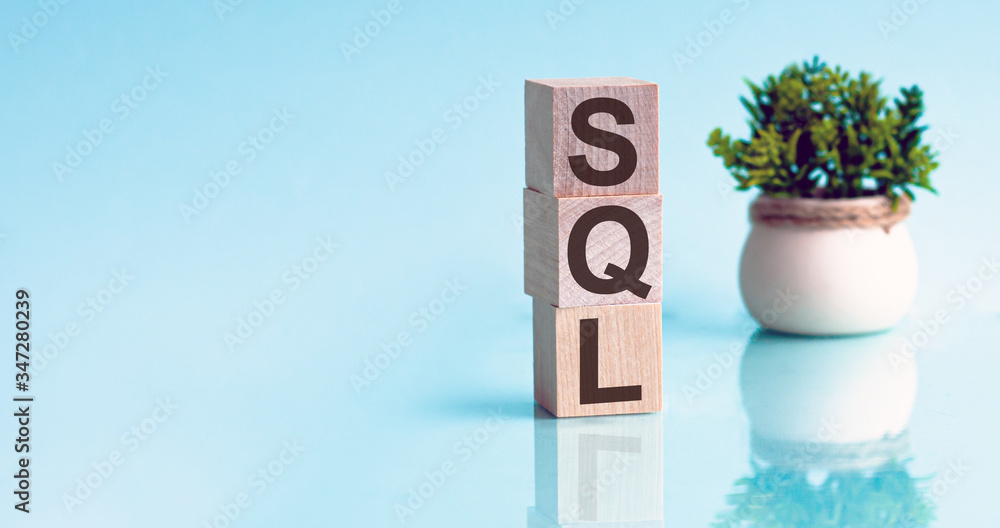 Poster the word sql structured query language, lined with wooden blocks on a blu textural background.