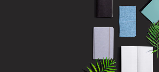 Collection of notebooks with tropical leaves - flat lay