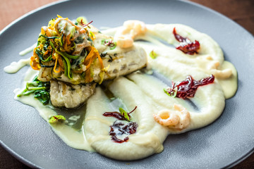 Cooked fish with potato purée and vegetables