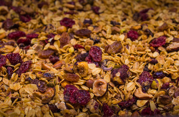 Closeup of roasted granola cereal mixed with dry fruits.