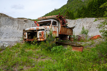 Truck wreck filled with scrap in the midle of nature