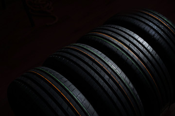Unused new tires set on a black background
