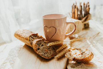 Bakery baker bread and milk. Fresh homemade bread on a table in the kitchen, organic breakfast