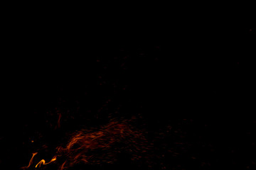 fire sparkles in the darkness of night black background space