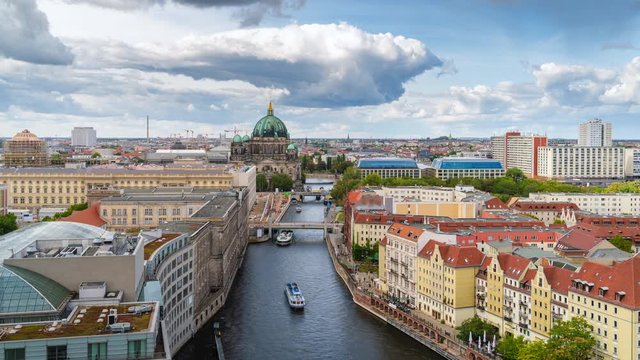 Berlin, Germany, zoom out timelapse view of tour boats on the Spree River including historial landmark Berlin Cathedral and Museum Island.