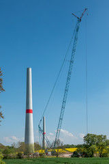 in wind farm, new wind turbines are erected with the help of a large crane