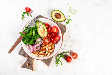 Healthy food. bowl dish with grilled Halloumi cheese, tomatoes, avocado, and arugula and sesame....
