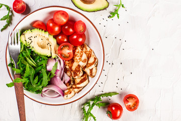 Buddha bowl dish with grilled Halloumi cheese, tomatoes, avocado, and arugula and sesame. Detox and healthy superfoods bowl concept. Overhead, top view, flat lay
