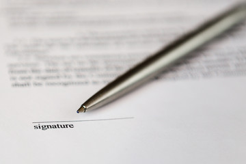 Space for signature on document and silver boll pen