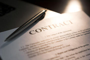Pen for signing the contract. The pen and contract are on the laptop.
