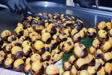 Roasting chestnuts on a street stall in Istanbul, Turkey. Selective focus.