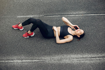 Beautiful girl at the stadium. Sports girl in a sportswear. Lady in a red sneakers