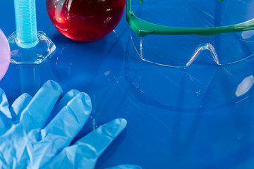 On the table are glass vials and safety glasses necessary for safety.