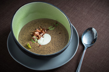 Vegetable cream soup with bacon and sour cream