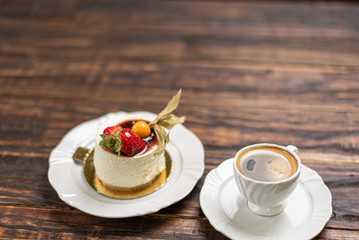Coffee cup and chocolate cake on wooden table background