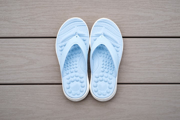 Light Blue Flipflops on Gray Deck Background