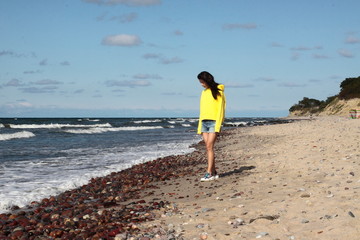 Baltic sea coast. Russia. The girl in yellow.