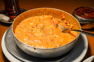 Traditional turkish food breakfast dish menemen made by eggs and tomatoes and different fillings