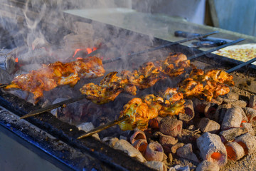 Roasted meat cooked at barbecue. Grilled kebab cooking on metal skewer. BBQ fresh beef meat