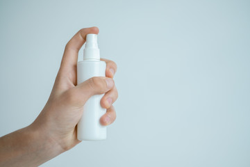 bottle in hand on a light background