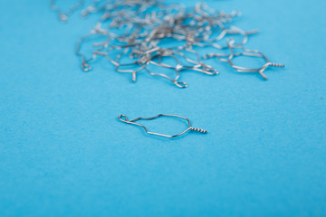 close-up of a set of metal ligatures. This is a thin wire or elastic rings that perform a bonding...
