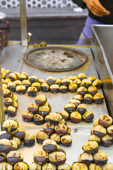 Roasting chestnuts on a street stall in Istanbul, Turkey. Selective focus.