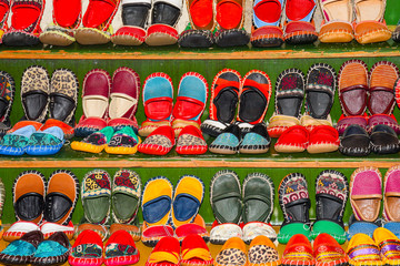 Children boy and girl shoes for sale. Multicolored sandals in turkish shop in Istanbul.