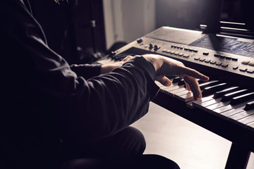 Hands playing a piano keyboard